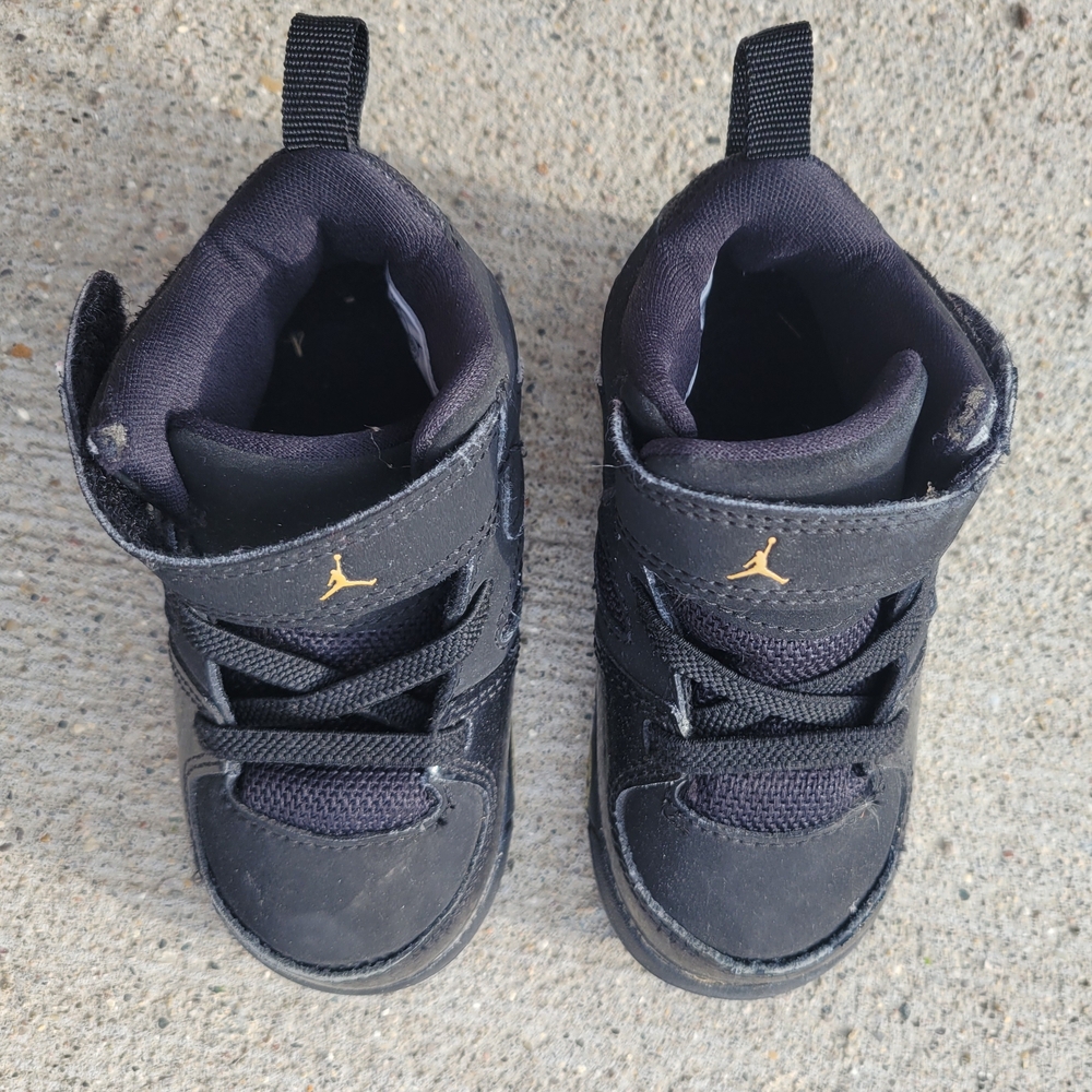 Kids Jordan Black and Gold Sneakers
